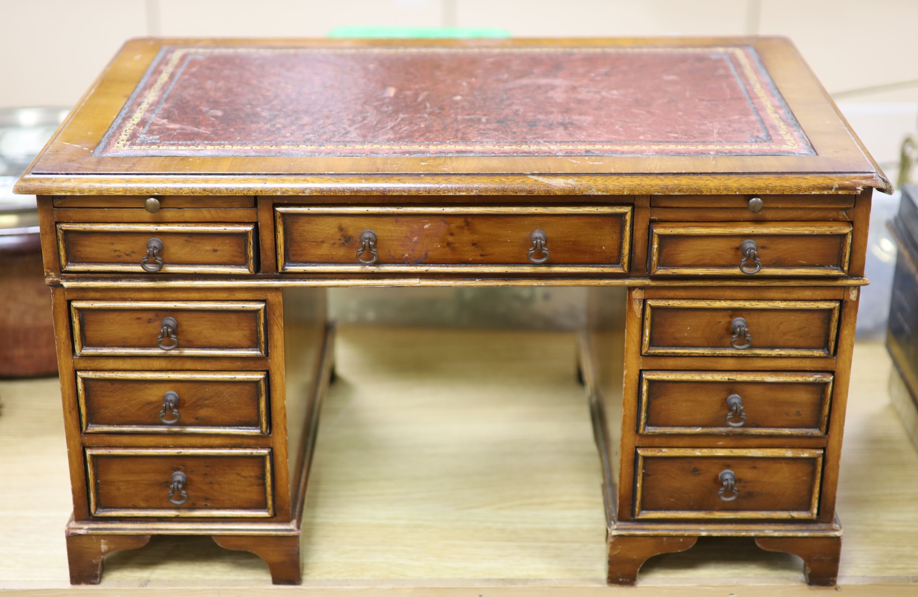 A miniature yew wood table top kneehole desk, length 52cm